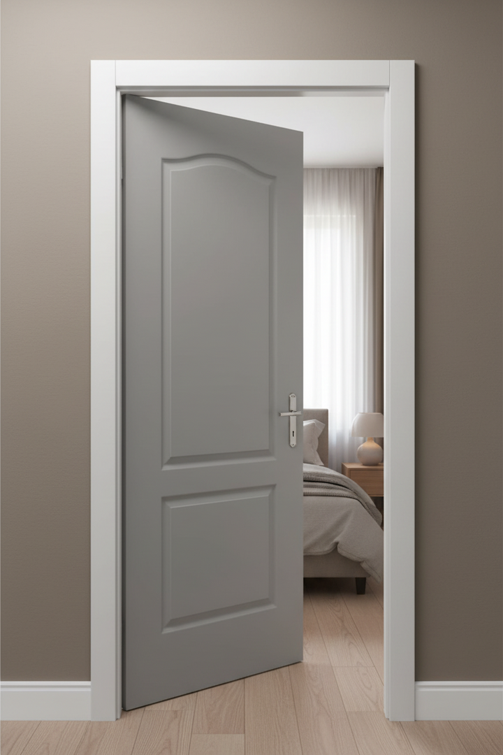 Gray Deep moulded door with white frame open in a room with a bed and lamp.