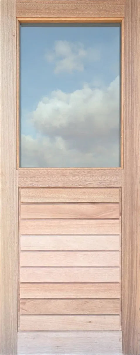 A tall, narrow wooden door with a rectangular glass window at the top and horizontal slats below, set against a cloudy blue sky.