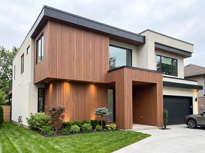 4 Everdeck® Rosewood Ultra Fluted PVC wall cladding installed vertically on the façade and entrance of a modern two-storey home.