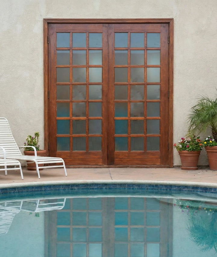 Wooden French doors with glass panels next to a pool